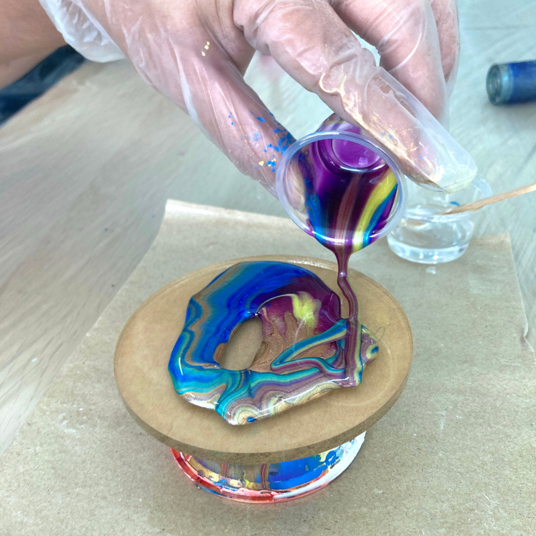 Artist pouring colorful resin for a UV resin and epoxy resin comparison