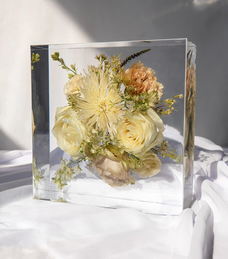Wedding bouquet flowers preserved in a thick clear resin block showing floral depth and clarity