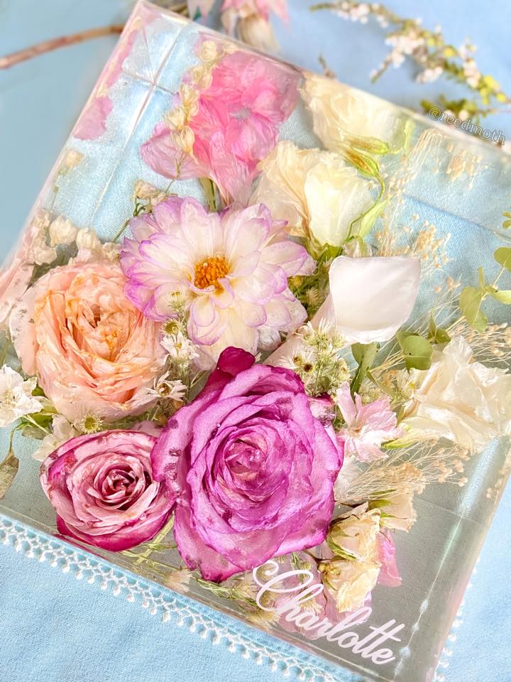 Wedding flowers preserved in clear epoxy resin keepsake block