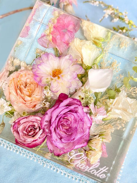 Wedding flowers preserved in clear epoxy resin keepsake block