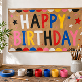 Hand-painted Happy Birthday banner on brown kraft paper with six paint colors